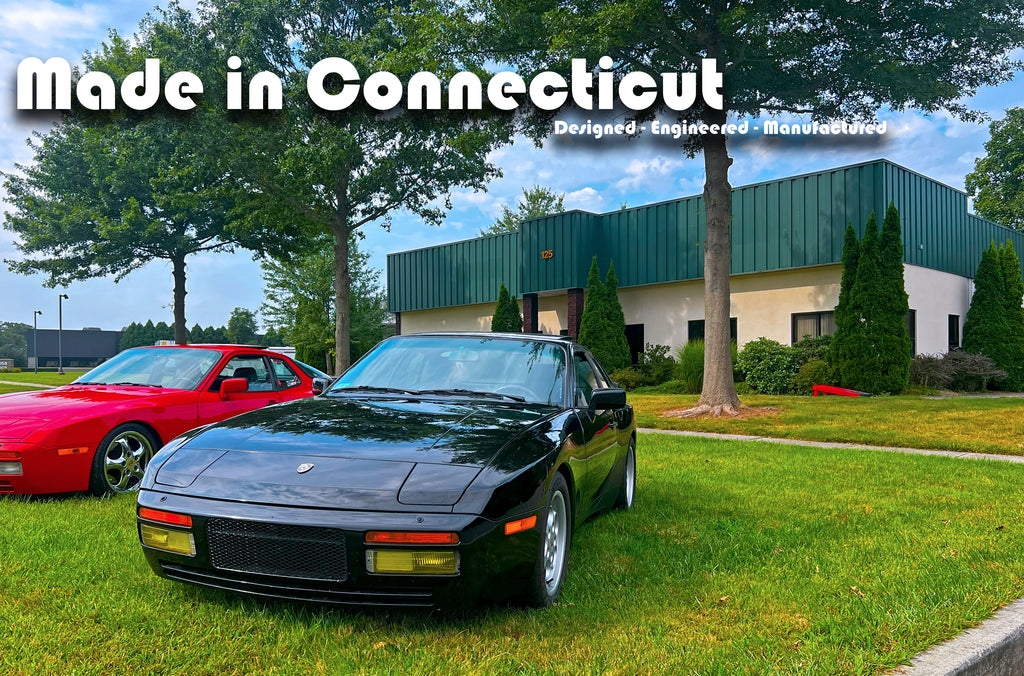 Two Porsche 944 Turbo cars outside of turboboof headquarters